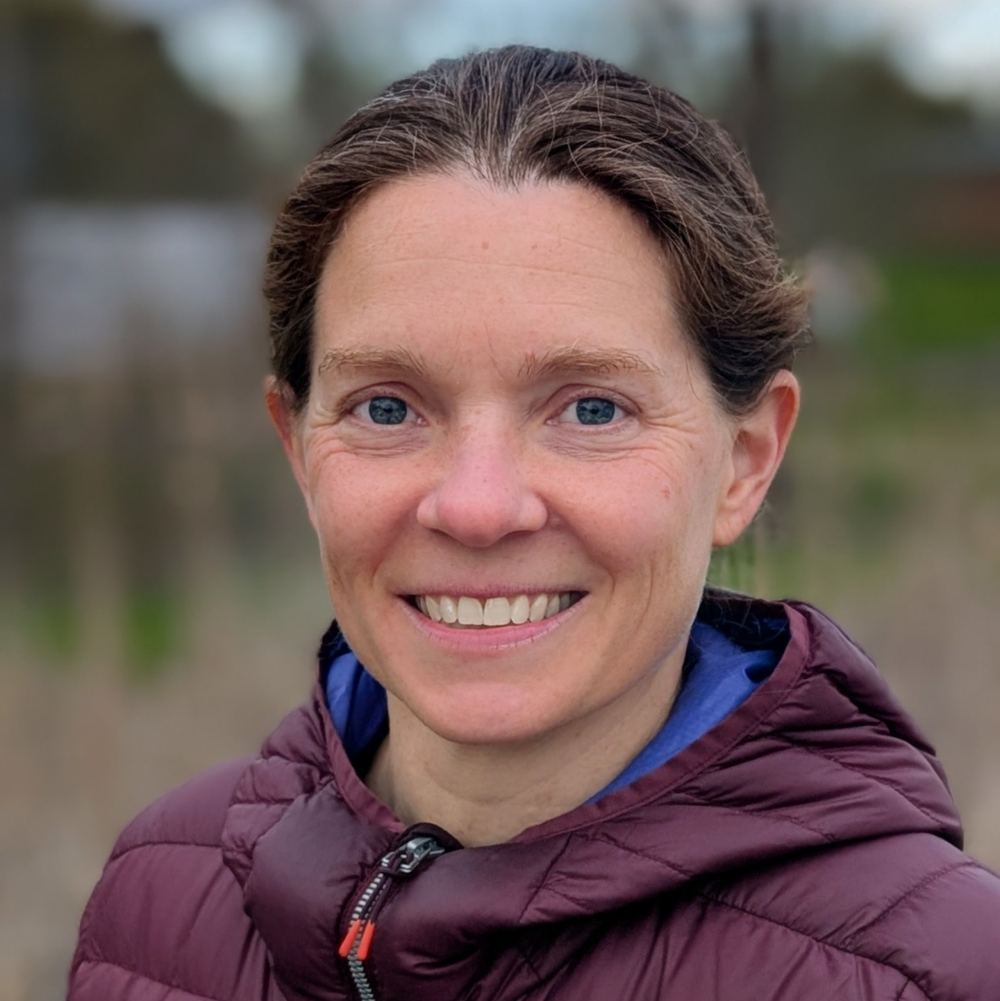 Portrait of Katie smiling in a winter coat